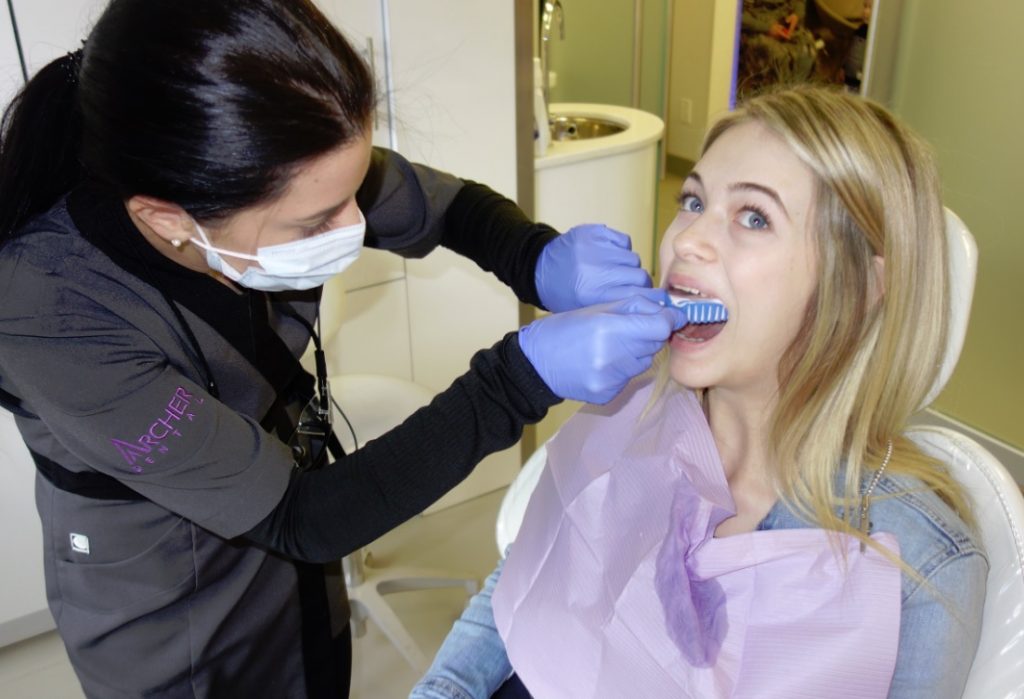 dental hygienist takes dental impressions after teeth cleaning 