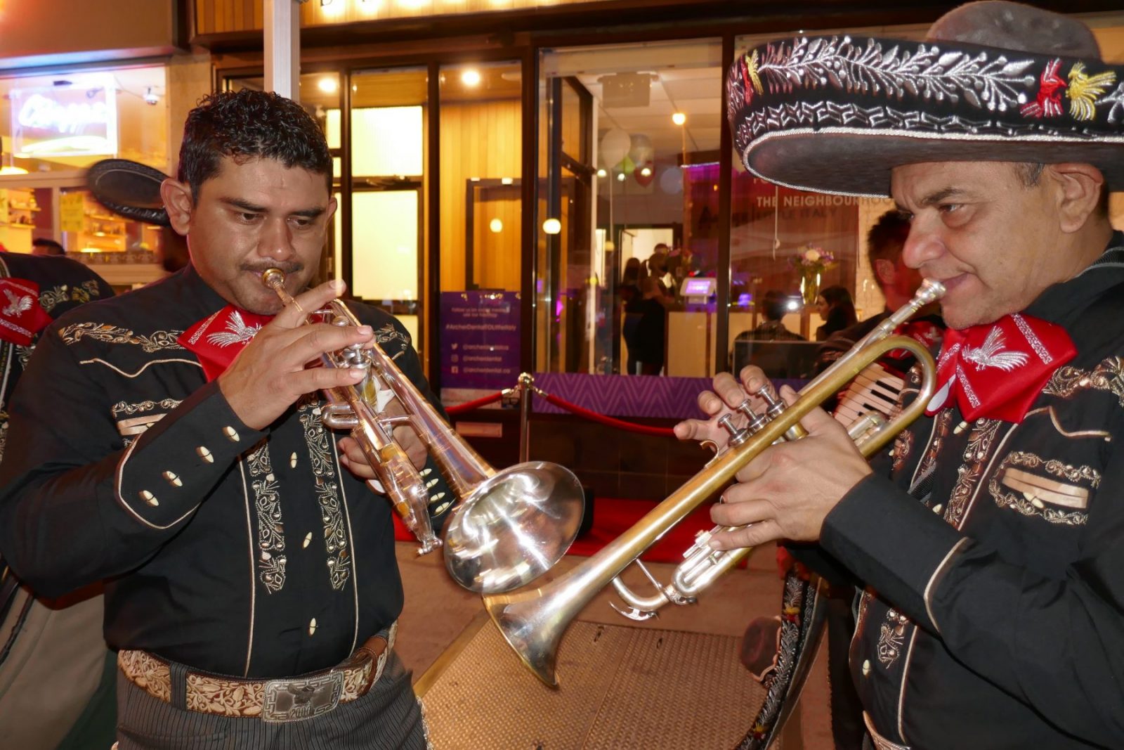 a mariachi band rehearses in front of Archer Dental Little Italy