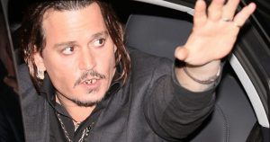 Johnny Depp waves goodbye showing gold teeth, veneers, gold capped teeth