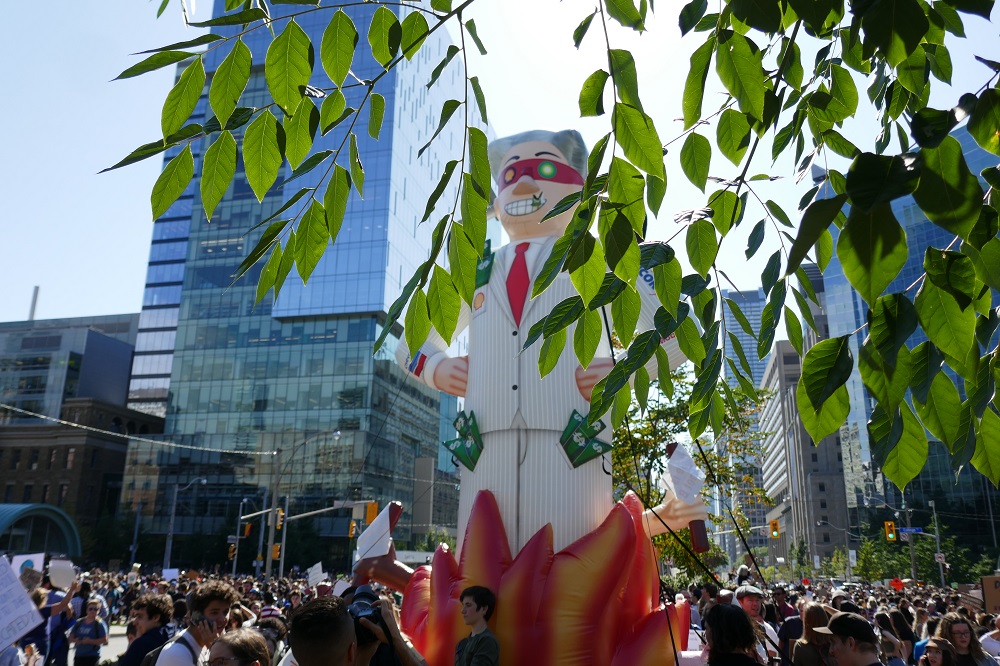 fossil fuel capitalist on fire at Climate Strike Toronto Friday Sept 27th 2019