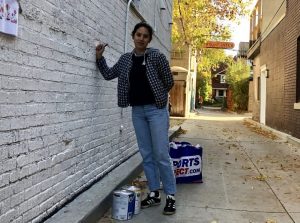 Vesna paints a wall mural in Toronto alley