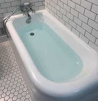 A drop of ink in a bathtub filled with water.
