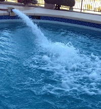A drop of ink in a swimming pool filled with water.