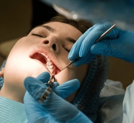 dentist removing wisdom tooth at Archer Dental